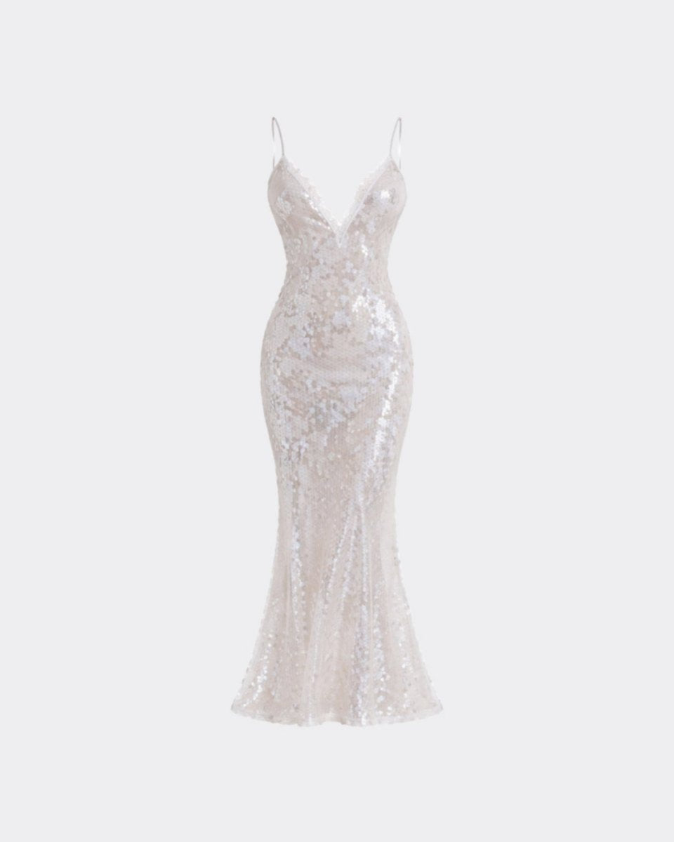 A floor-length champagne sequin gown with spaghetti straps and a V-neckline, shown against a light gray background.