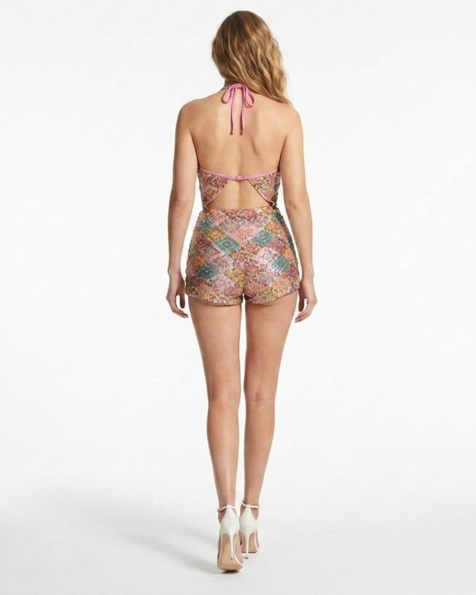 Woman wearing a colorful patterned romper on a white background