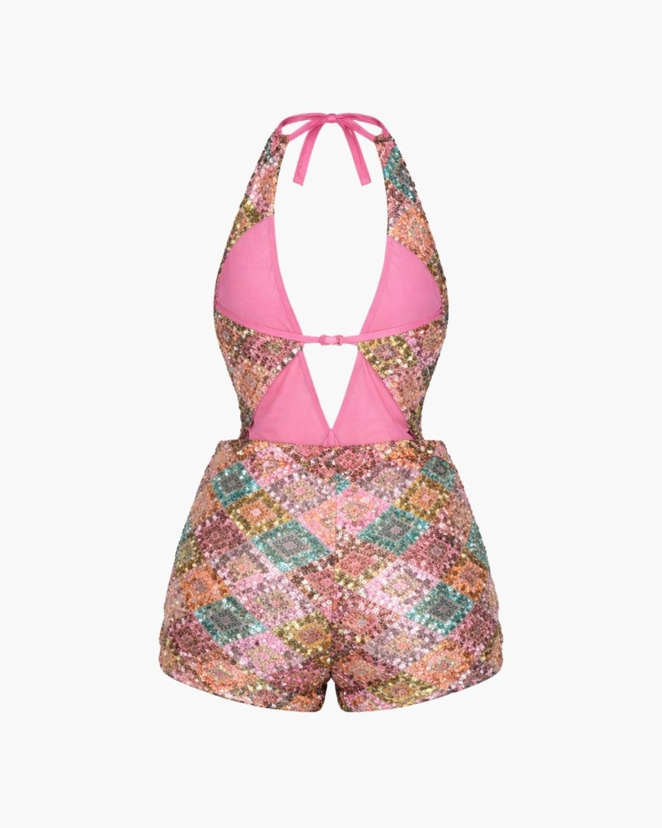 Multicolored patterned romper with pink top on a white background